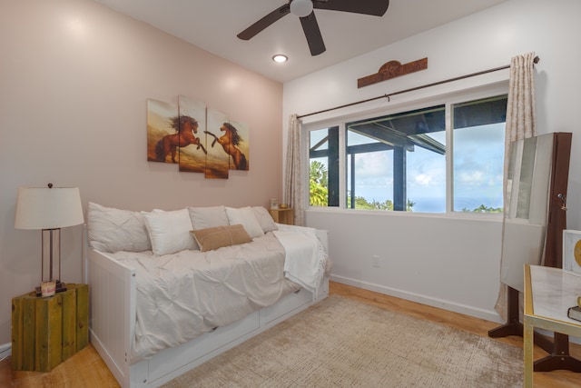 bedroom with ceiling fan and light wood-type flooring