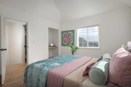 bedroom featuring hardwood / wood-style floors and vaulted ceiling