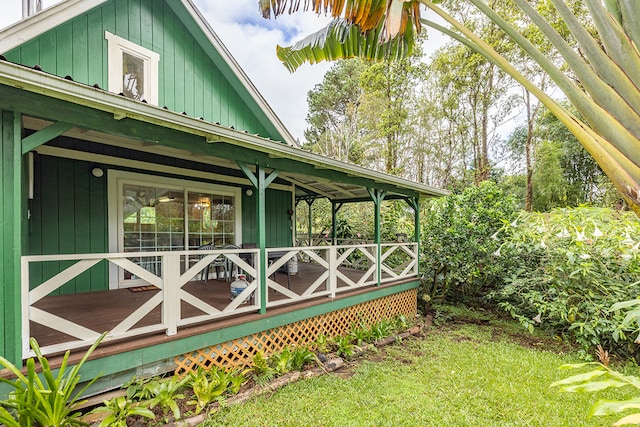 view of side of property featuring covered porch