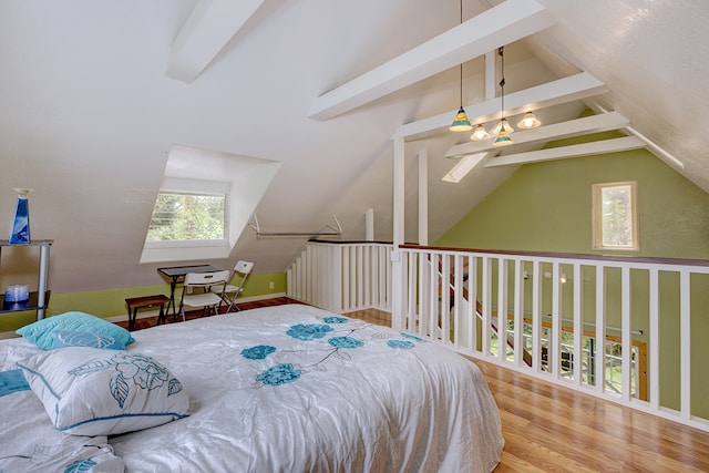 bedroom with vaulted ceiling with beams and wood-type flooring