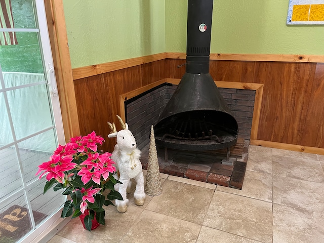 interior details featuring a wood stove and wooden walls