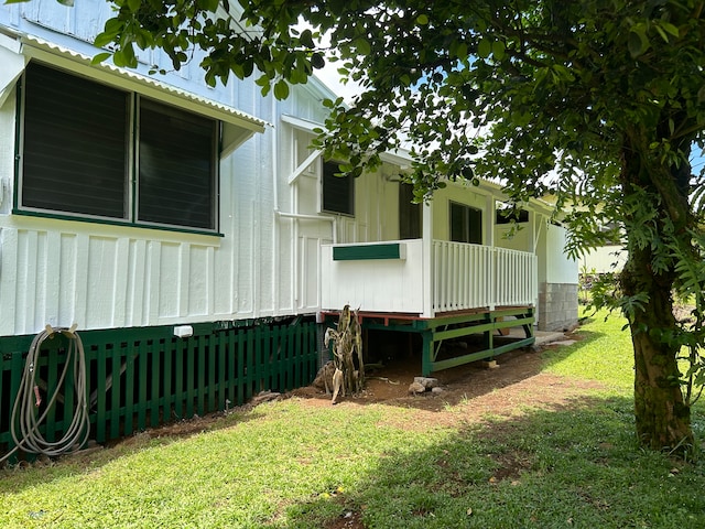 view of side of property with a yard