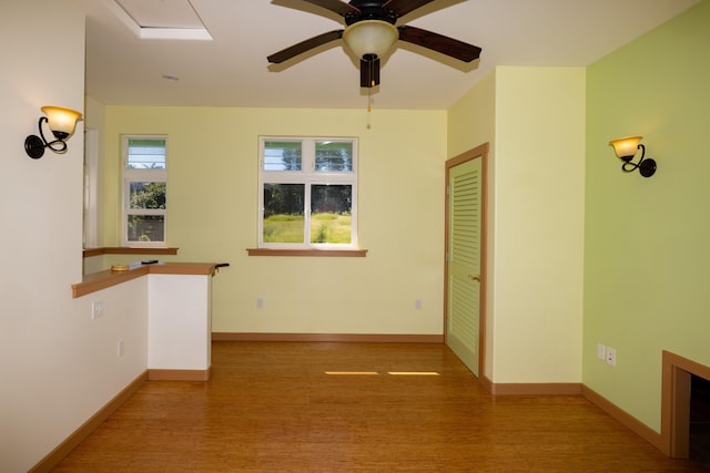 empty room featuring hardwood / wood-style flooring and ceiling fan