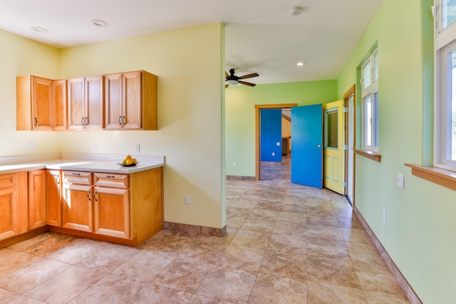 kitchen featuring ceiling fan and a wealth of natural light