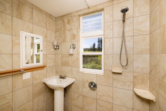 bathroom featuring a tile shower and tile walls