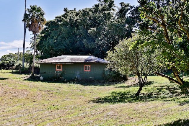 view of side of home with a lawn