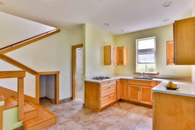 kitchen featuring sink, light tile patterned flooring, and gas stovetop