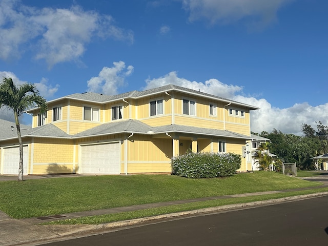 view of front of house with a front lawn and a garage