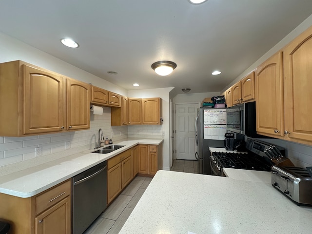 kitchen with decorative backsplash, light tile patterned floors, sink, and black appliances