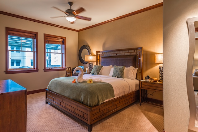 carpeted bedroom with ceiling fan and crown molding