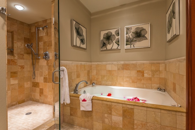 bathroom featuring plus walk in shower and tile patterned flooring