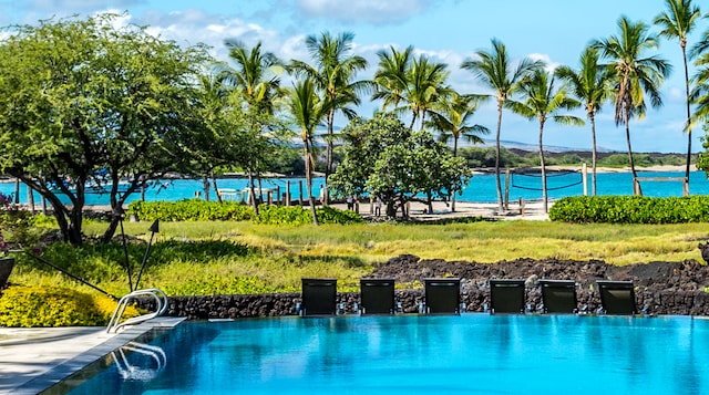 view of swimming pool with a water view