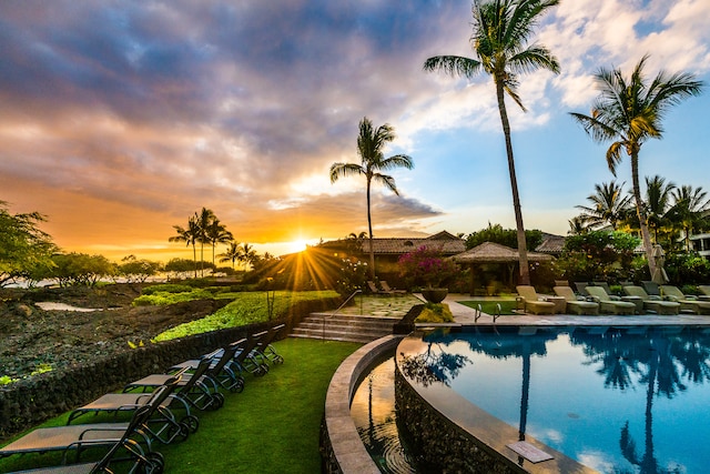 pool at dusk with a yard