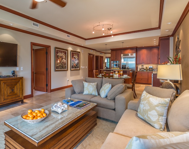 tiled living room featuring a raised ceiling, ceiling fan, and crown molding