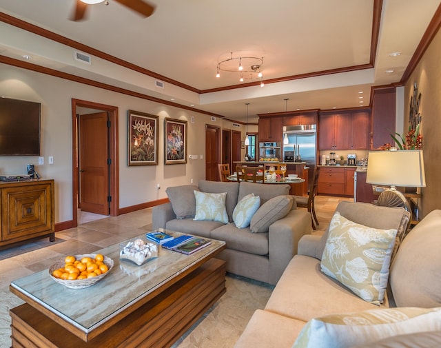 69-1000 Kolea Kai Cir Unit 9E, Waikoloa, HI 96738 - living room featuring ornamental molding, ceiling fan, a tray ceiling, baseboards, and rail lighting