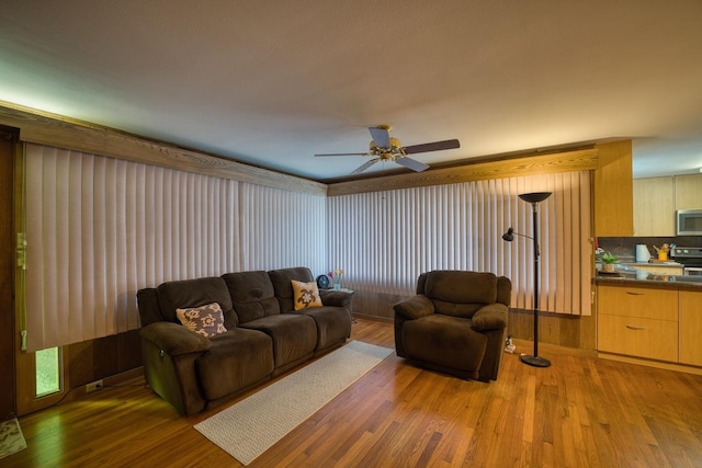 living room featuring hardwood / wood-style flooring and ceiling fan