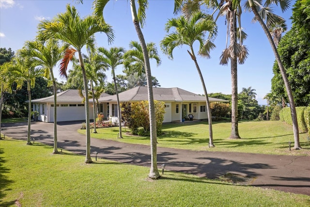 view of front of property featuring a garage and a front lawn