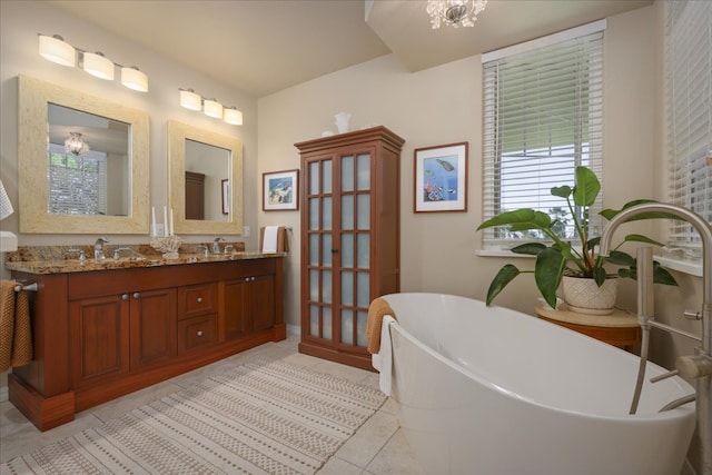 bathroom featuring a bath, vanity, tile patterned floors, and a notable chandelier