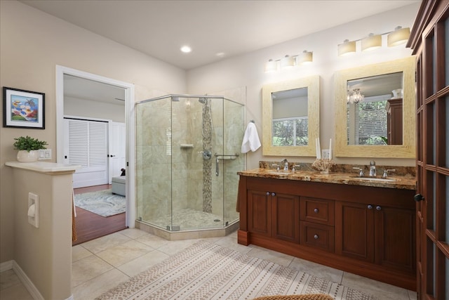 bathroom featuring tile patterned floors, vanity, and walk in shower