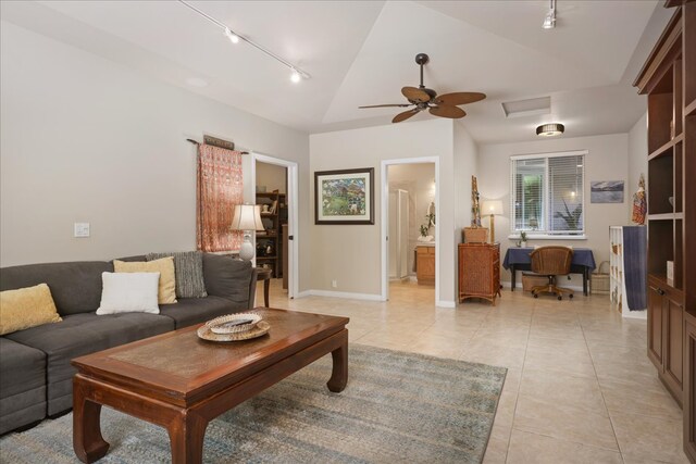 tiled living room with vaulted ceiling, ceiling fan, and track lighting