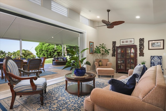 living room featuring ceiling fan and high vaulted ceiling