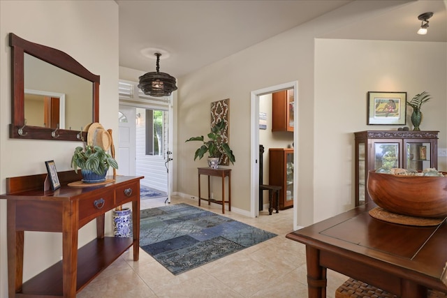 tiled entryway featuring lofted ceiling