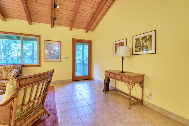 tiled entryway with vaulted ceiling with beams, plenty of natural light, and wood ceiling