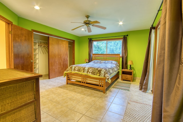 bedroom with light tile patterned floors, a closet, and ceiling fan