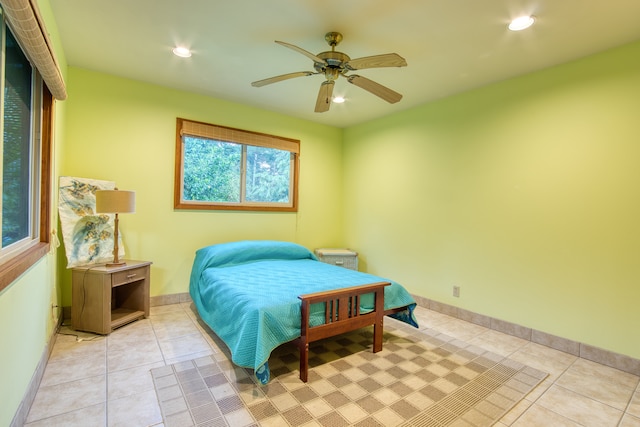 bedroom with ceiling fan and light tile patterned flooring