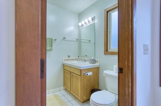 bathroom with tile patterned flooring, vanity, and toilet