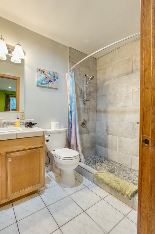 bathroom with vanity, toilet, and walk in shower