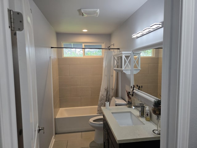 bathroom with tile patterned flooring, a healthy amount of sunlight, vanity, and toilet