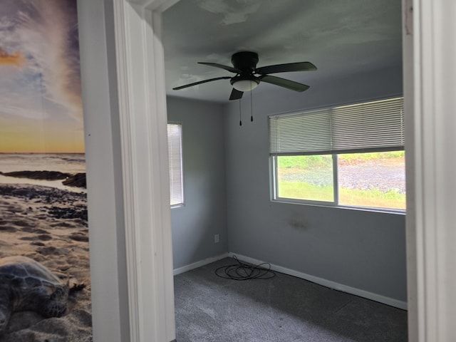 spare room featuring ceiling fan, baseboards, and carpet flooring