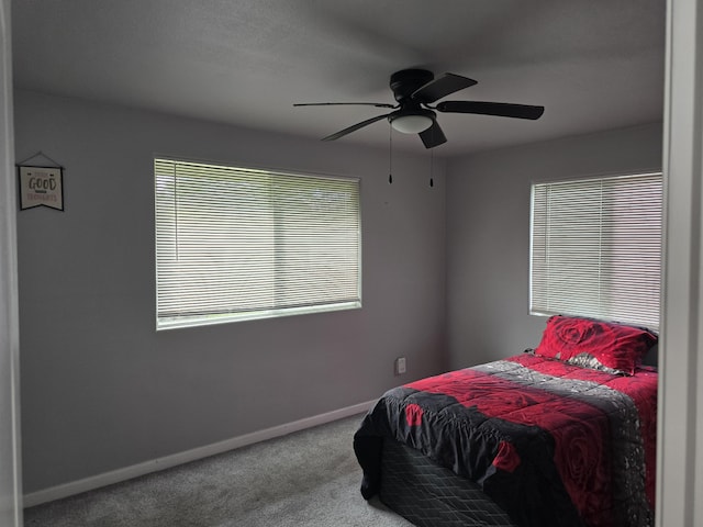 carpeted bedroom with baseboards and a ceiling fan