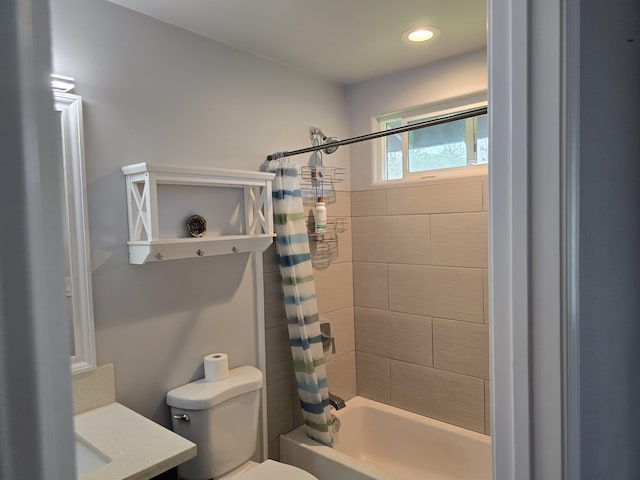 bathroom with toilet, shower / tub combo with curtain, and vanity