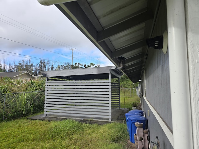 view of outbuilding featuring fence