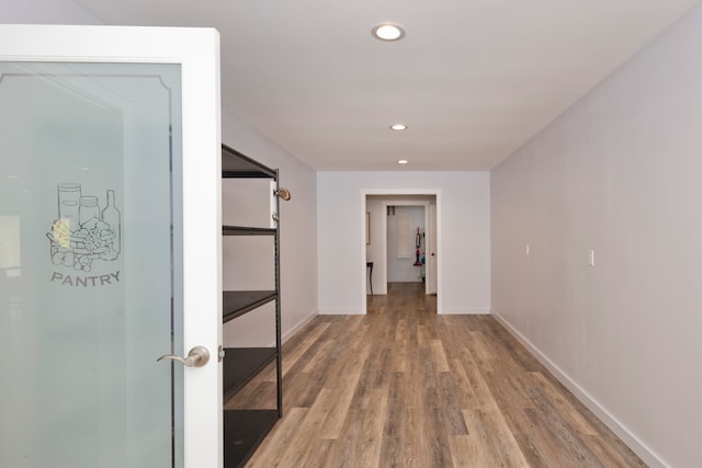 hall with hardwood / wood-style floors