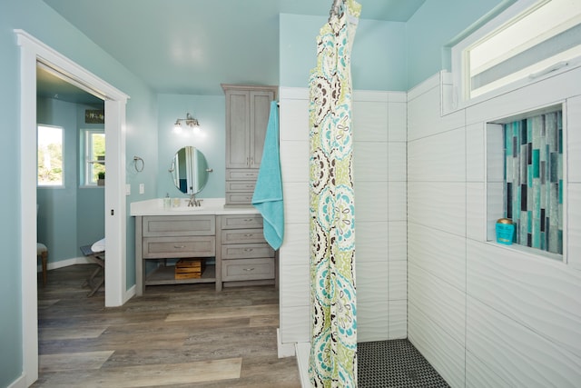 bathroom featuring toilet, wood-type flooring, vanity, and a shower with curtain