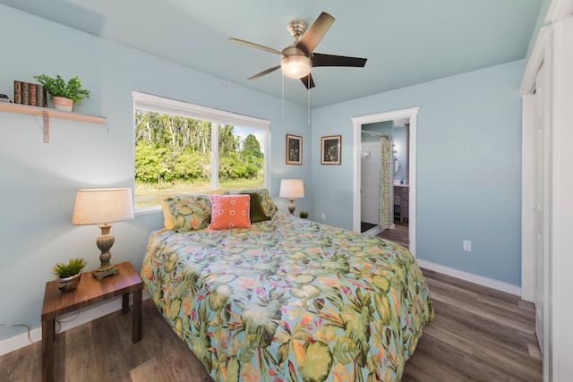 bedroom with dark hardwood / wood-style flooring, ceiling fan, and connected bathroom