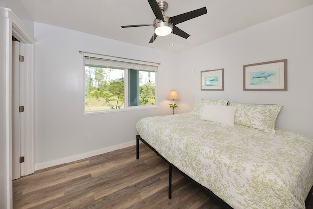 bedroom with ceiling fan and dark wood-type flooring