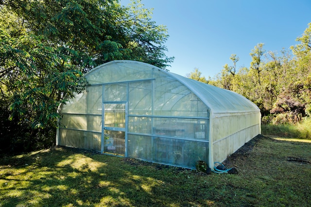 view of outbuilding with a lawn