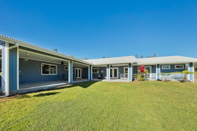 rear view of house featuring a yard and a patio