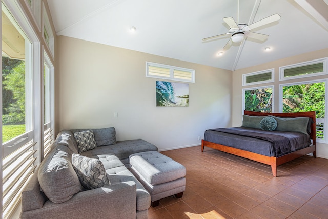 bedroom featuring ceiling fan, dark tile patterned floors, and lofted ceiling