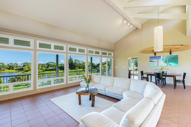 living room featuring high vaulted ceiling, a water view, rail lighting, beamed ceiling, and light tile patterned flooring