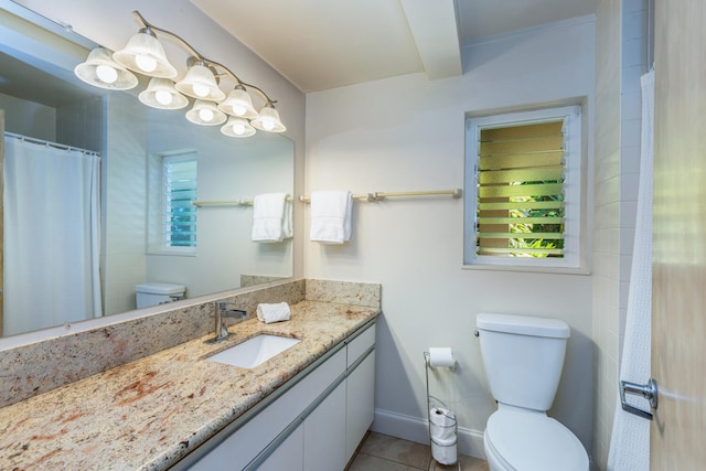 bathroom with tile patterned flooring, vanity, and toilet