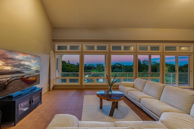 living room with light tile patterned floors and vaulted ceiling