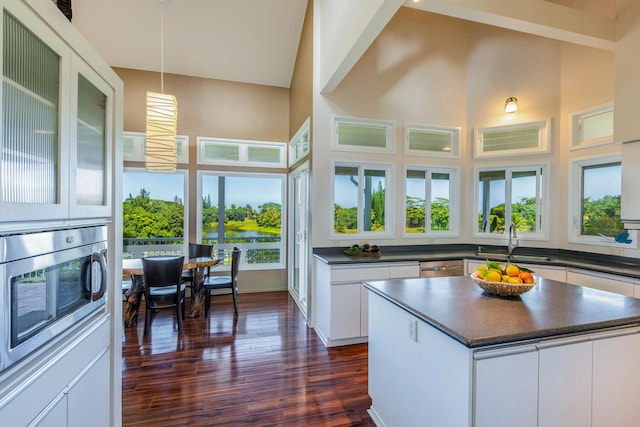 kitchen with sink, white cabinets, a kitchen island, and appliances with stainless steel finishes