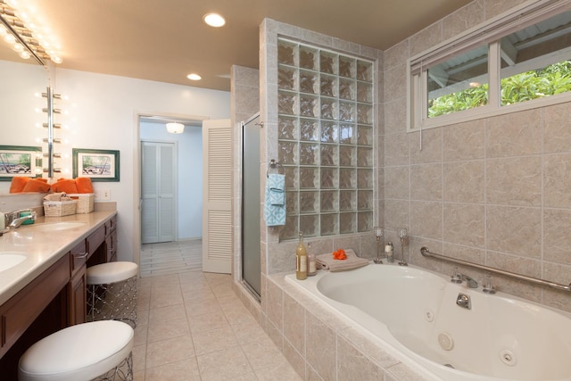 bathroom with tile patterned floors, vanity, and shower with separate bathtub