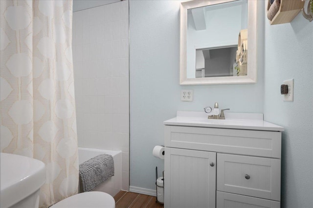 full bathroom with vanity, hardwood / wood-style flooring, toilet, and shower / bath combo with shower curtain