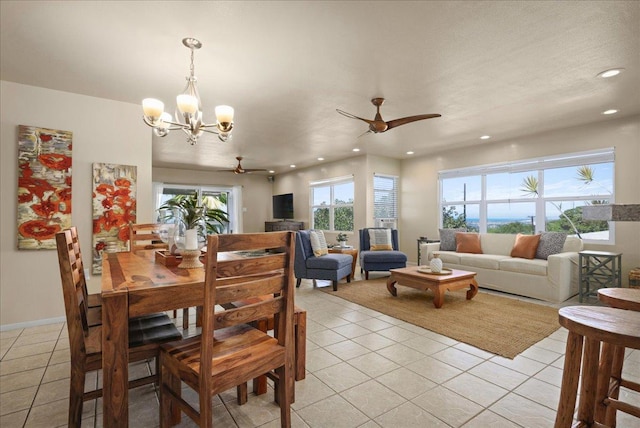 tiled dining room featuring ceiling fan with notable chandelier